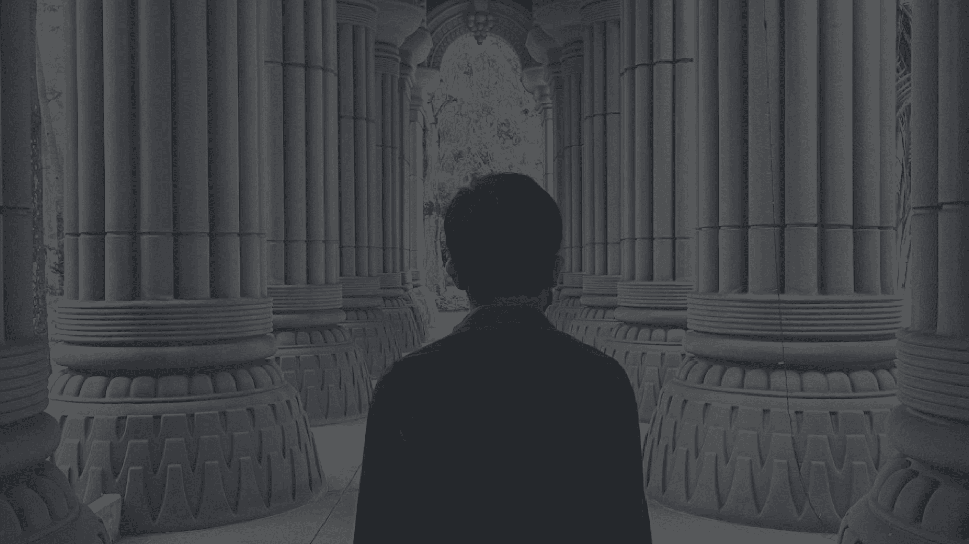 A man standing facing backwards.