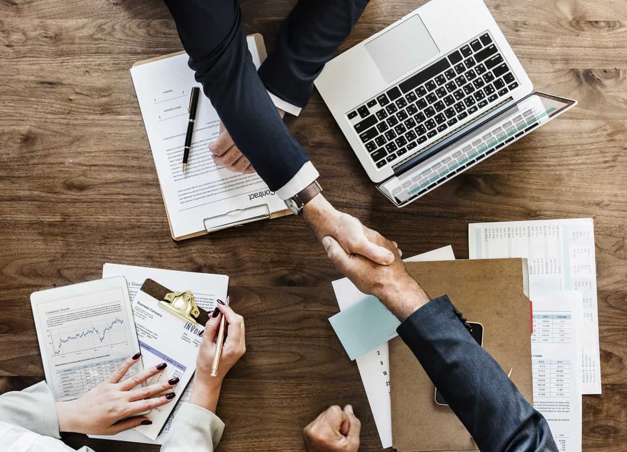 Two men shaking hands from top of POV.